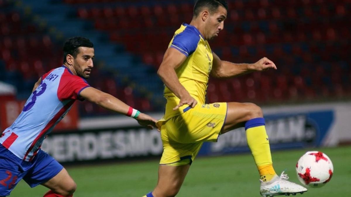 El jugador iraní Ehsan Hajsafí, del Panionios (a la izquierda) disputa el balón con Eyal Golasa, del Maccabi, en el partido disputado en Atenas el pasado día 3.