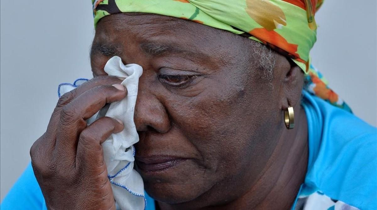 jjubierre36446013 a woman dries her tears as she waits to pay the last respect161128163346