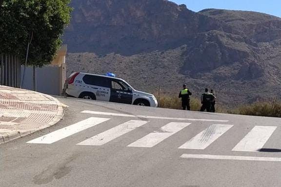 Un coche patrulla vigila los accesos a la Urbanización de Las Colinas, en Aguadulce (Almería).
