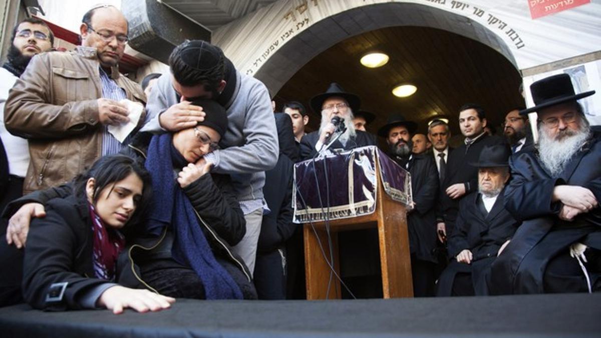 Family of victim of attack on a Paris grocery mourn beside a symbolic coffin during a procession near Tel Aviv