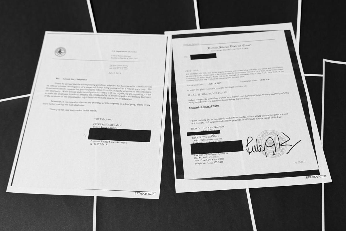 Pages that show New York grand jury subpoenas being issued into the Jeffrey Epstein and Ghislaine Maxwell investigation, then pages of redactions that follow, in this document released by the U.S. Justice Department, are photographed, Friday, Dec. 19, 2025, in Washington. (AP Photo/Jon Elswick)