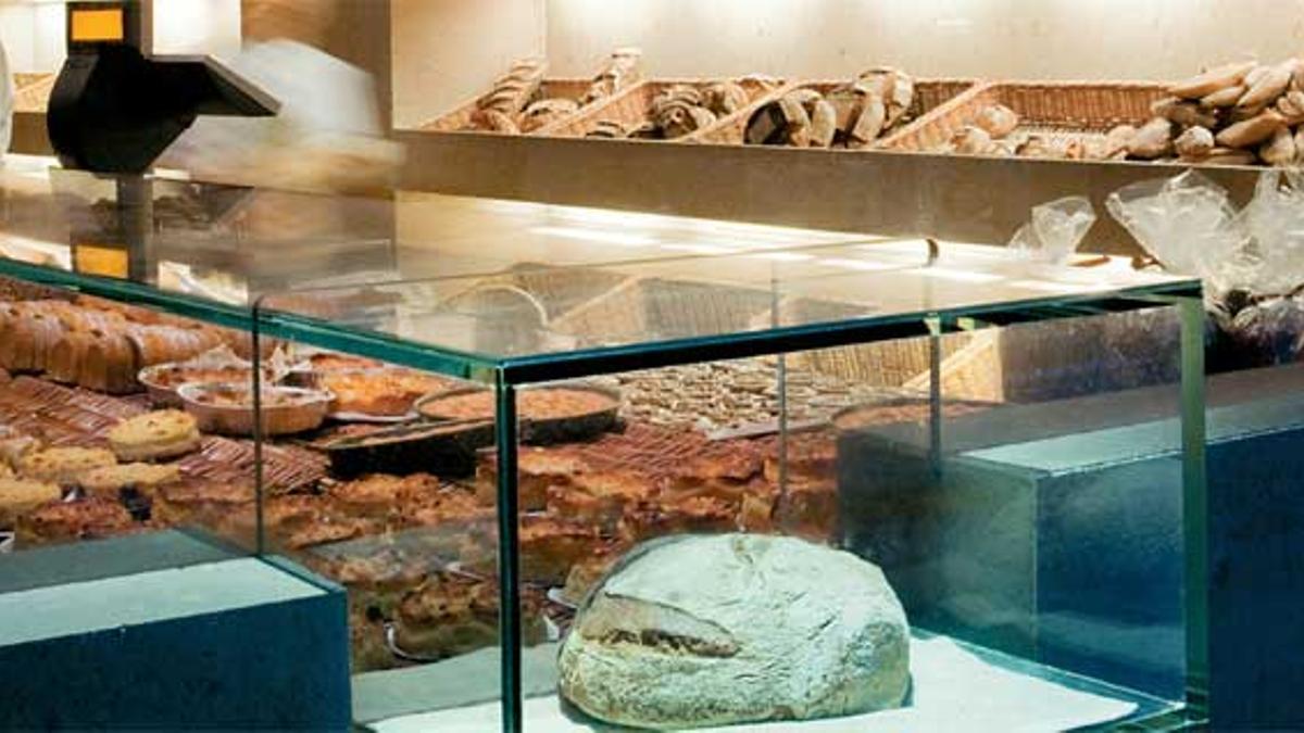 1. Panadería Princi. Suescaparate exhibe una hogazaen una vitrina y el interiorismoes digno de l