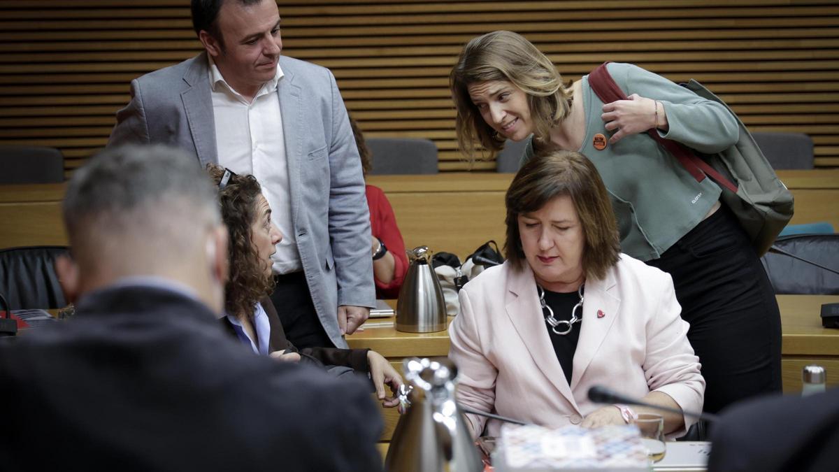 Paula Espinosa habla con los diputados socialistas en la comisión Ramón Abad, Ana Besalduch y Charo Navalón, este martes.