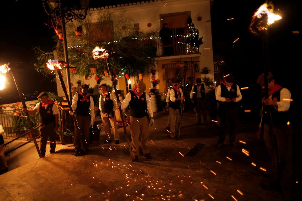 Villagers hold torches during the Divina Pastora ...