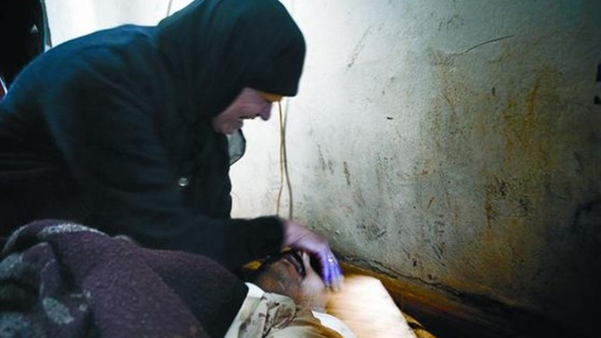 LLANTO POR LA PÉRDIDAUna mujer siria vela el cadáver de su sobrino abatido por un francotirador en Al Qsair.