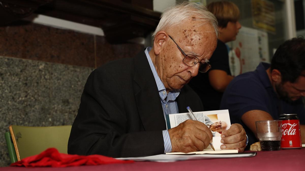 Pedro Fuertes firma uno de sus libros de poemas.