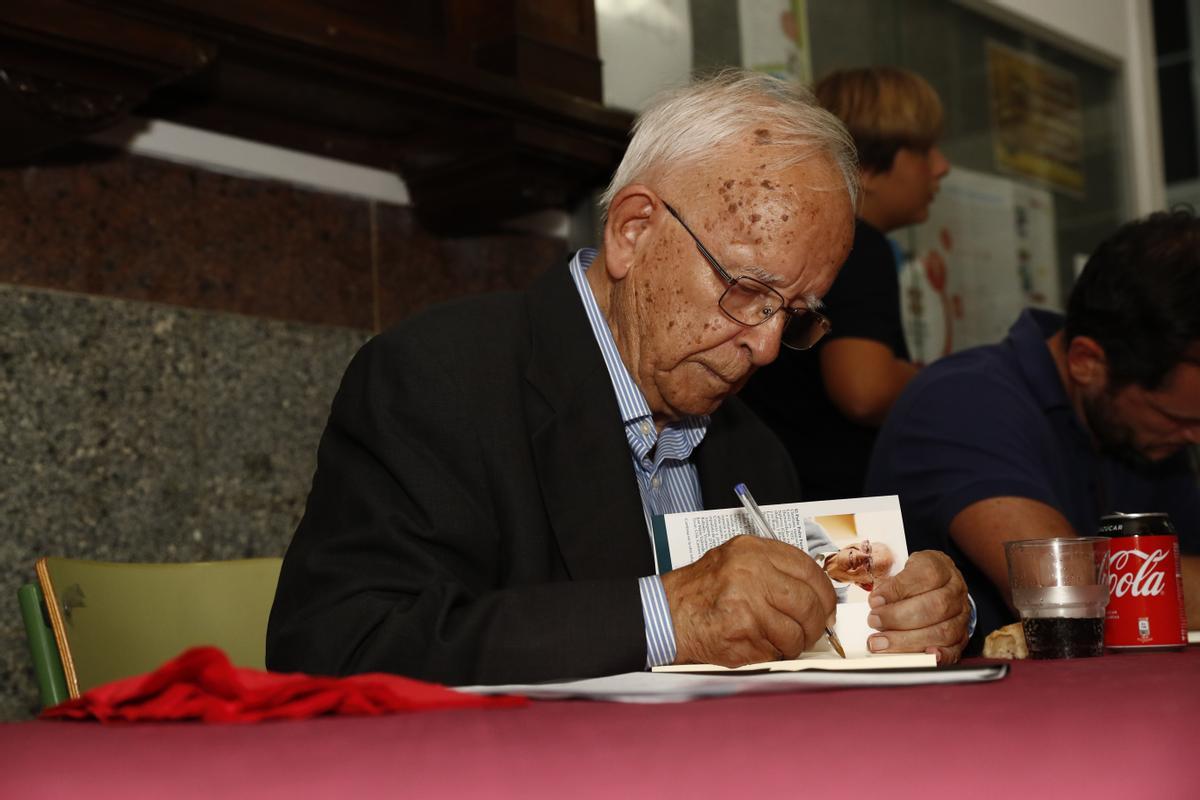 Pedro Fuertes firma uno de sus libros de poemas.