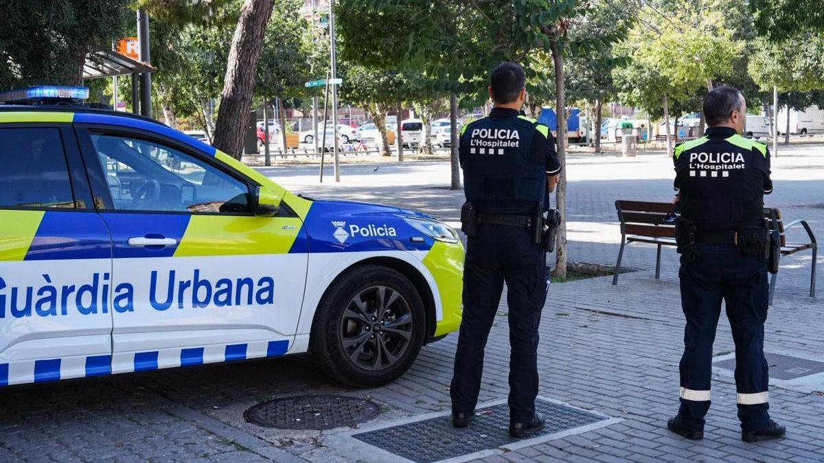 Dos agentes de la Guardia Urbana de L'Hospitalet, junto a la estación de Bellvitge-Gornal de Rodalies.
