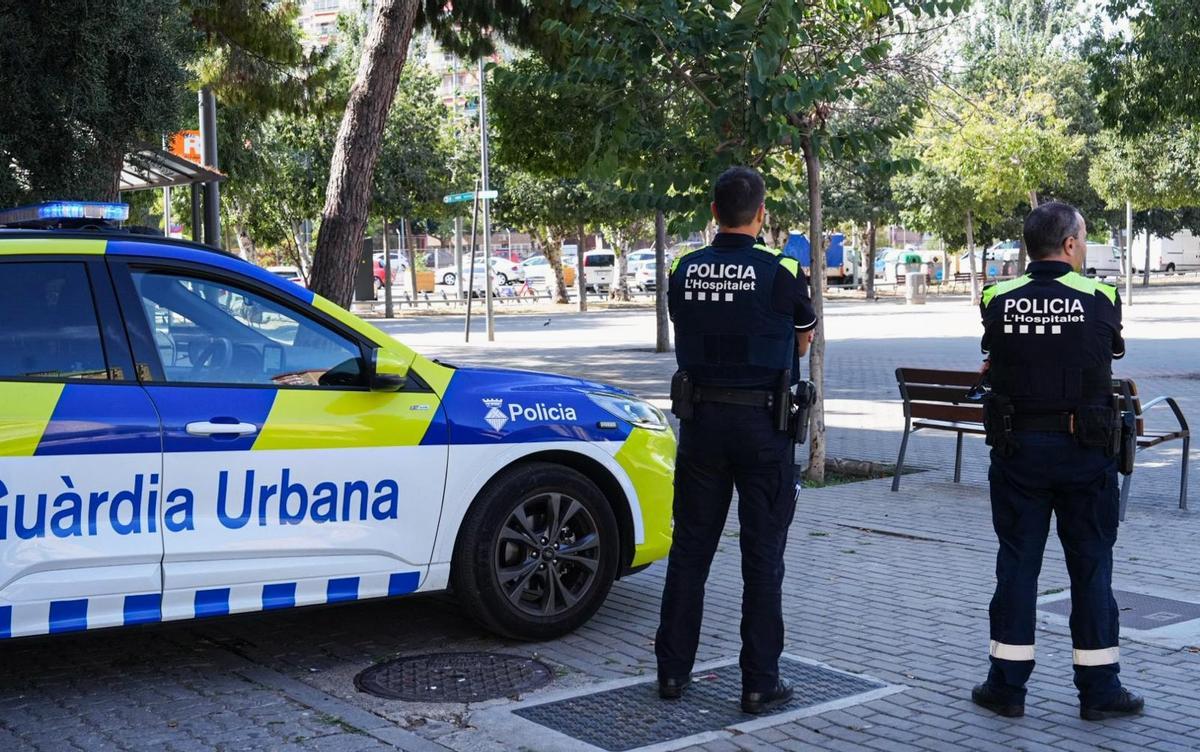Dos agentes de la Guardia Urbana de L'Hospitalet, junto a la estación de Bellvitge-Gornal de Rodalies.