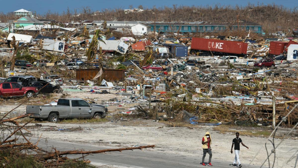 Two men amid the devastation of a hurricane in the Bahamas. Two men amid the devastation of a hurricane in the Bahamas.