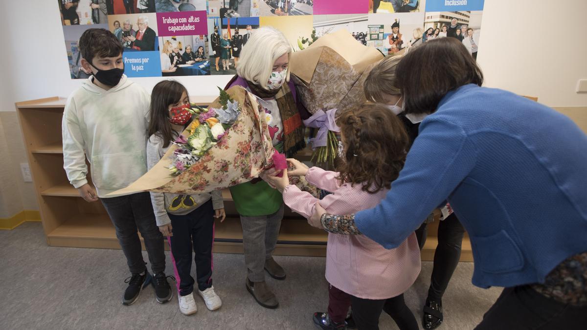 Los niños del colegio entregan flores a Maite Fernández