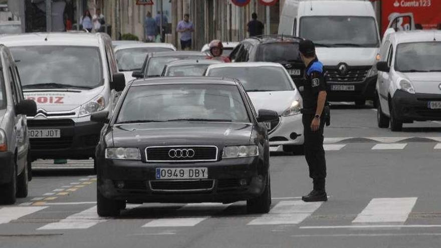 Un agente de la Policía regula el tráfico en el centro de Bueu. // S.Á.