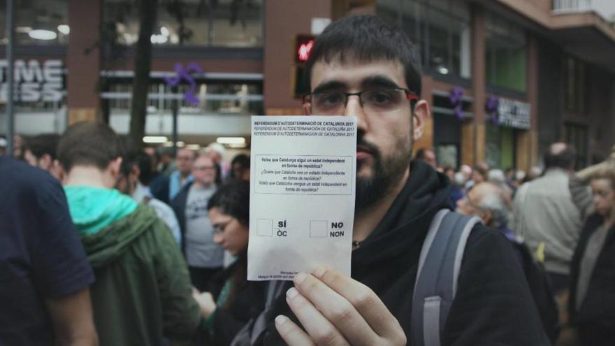 Un ciutadà, mostrant una papereta l&#039;1 d&#039;octubre.
