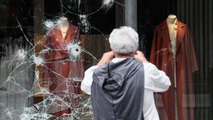 Un hombre observa un escaparate atacado el pasado 22 de agosto de 2021 en San Sebastián, en otra madrugada de disturbios.