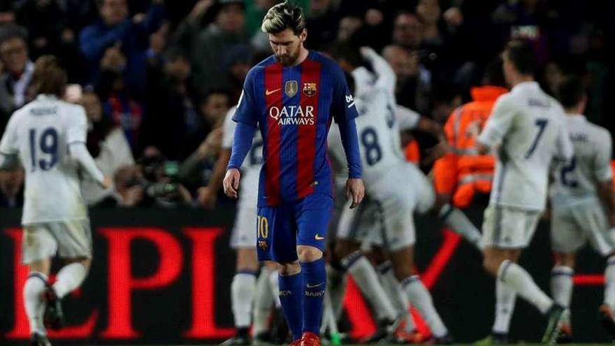 Messi, cabizbajo mientras los jugadores del Madrid celebran el gol del empate a sus espaldas.