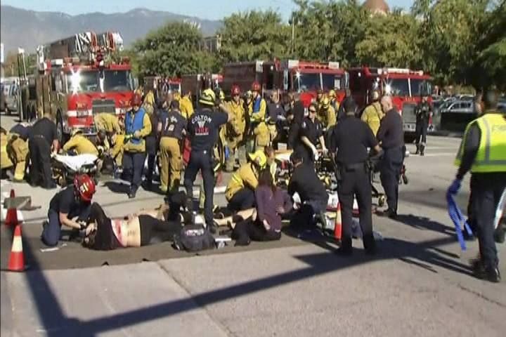 Still from video shows rescue crews tending to the injured in the intersection outside the Inland Regional Center in San Bernardino