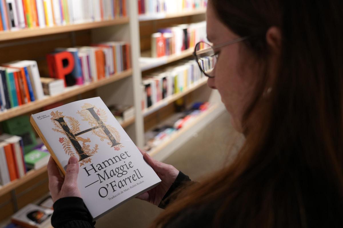Una lectora mira la portada de l'edició en català de "Hamnet"