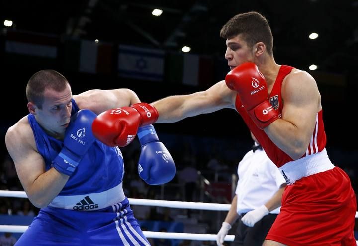 Pervizaj of Germany fights with Ialimov of Moldova during their men's 91kg round of 32 boxing fight at the 1st European Games in Baku