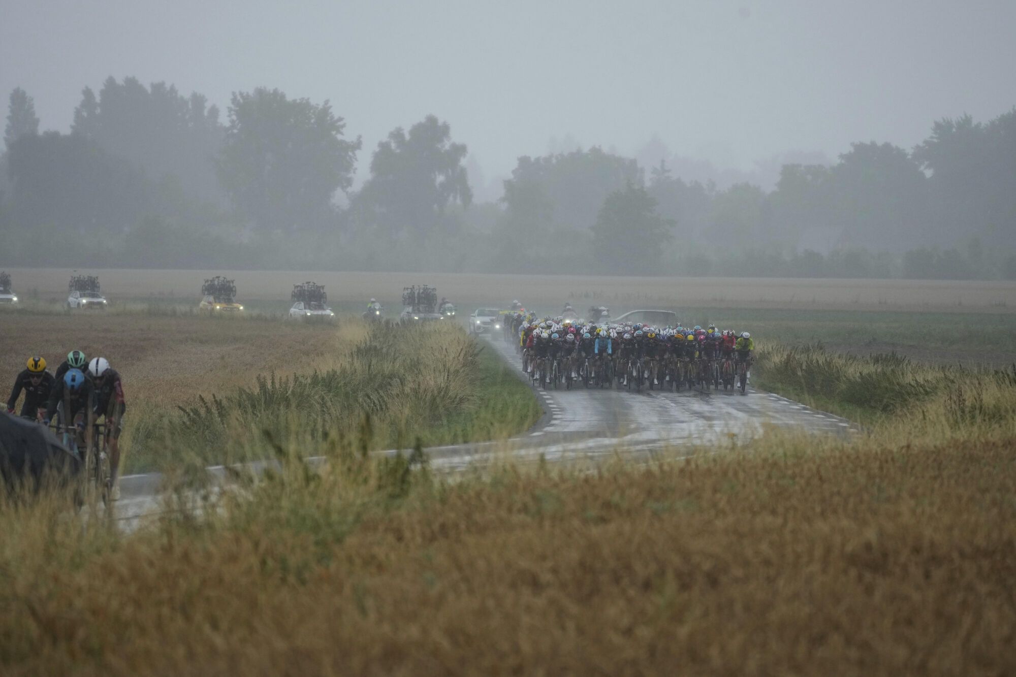 The pack and breakaway ride during the second stage of the Tour de France cycling race over 209.1 kilometers (129.9 miles) with start in Lauwin-Planque and finish in Boulogne-sur-Mer, France, Sunday, July 6, 2025. (AP Photo/Thibault Camus). EDITORIAL USE ONLY/ONLY ITALY AND SPAIN