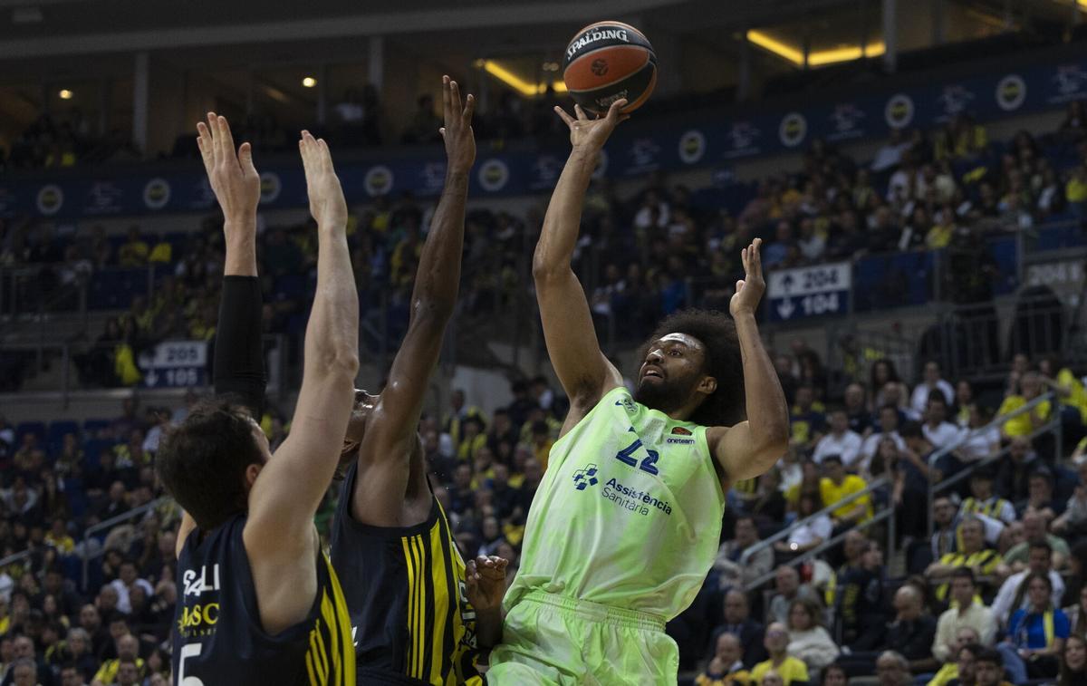 Sertac Sanli y Nigel Hayes-Davis, intentan parar a Jabari Parker.