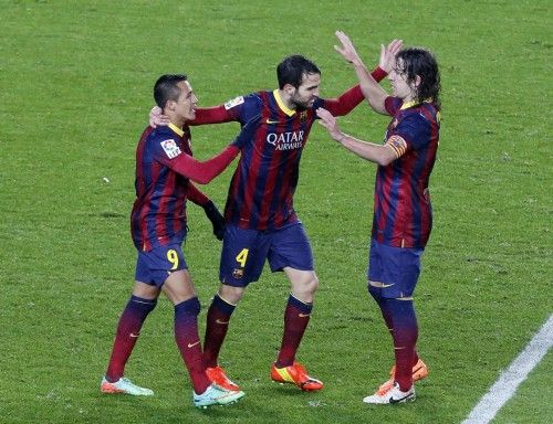 Barcelona's Cesc Fabregas celebrates his goal with teammates Alexis Sanchez and Carles Puyol during their Spanish King's Cup soccer match against Levante at Nou Camp stadium in Barcelona