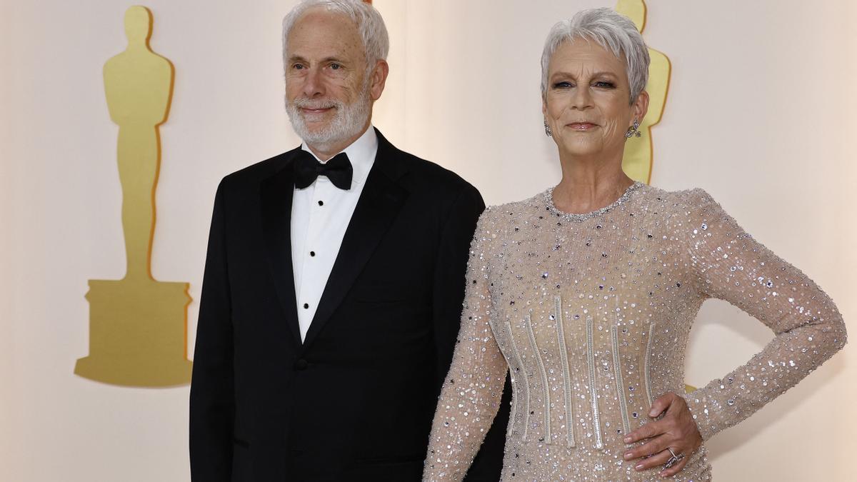 La actriz Jamie Lee Curtis y su marido Christopher Guest posando en la alfombra color champán a su llegada a la 95 edición de la gala de los Oscars 2023 