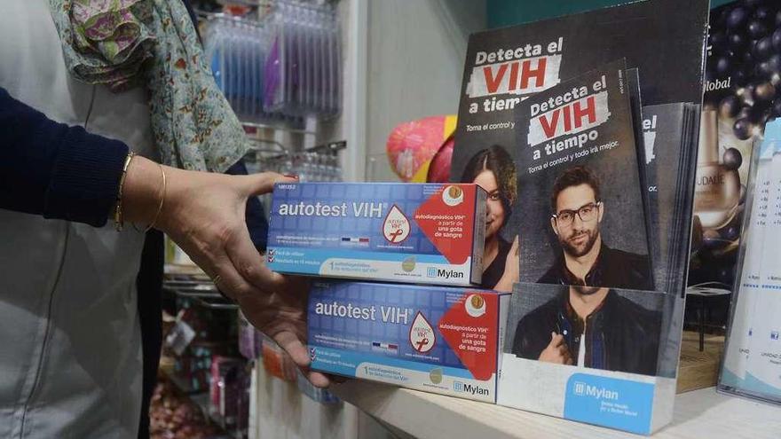 Una farmacéutica de la Praza de España muestra los autotest del VIH junto a folletos informativos. // R.V