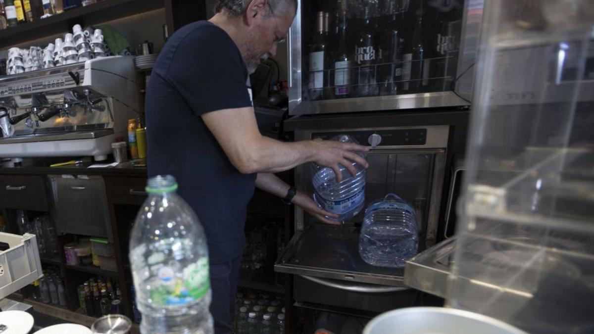 Horacio Fernández González, trabajando con agua embotellada en su cafetería de Posada. | Miki López