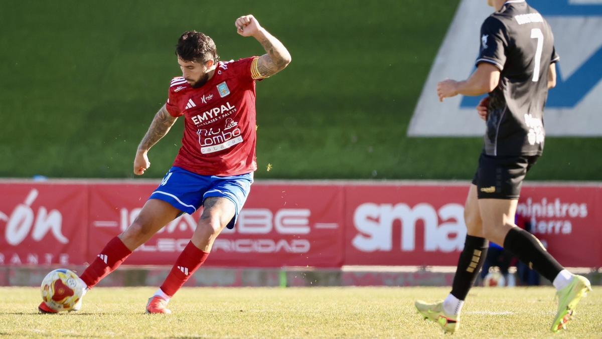 El capitán del Tarazona lanza un balón en largo frente a un jugador del Algeciras.
