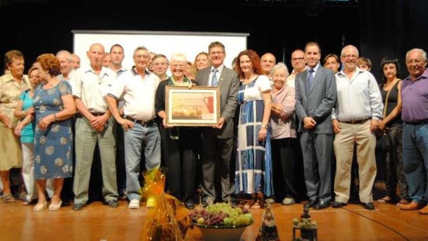 Schütz y el alcalde, con el título de hija adoptiva, rodeados por asistentes al evento.