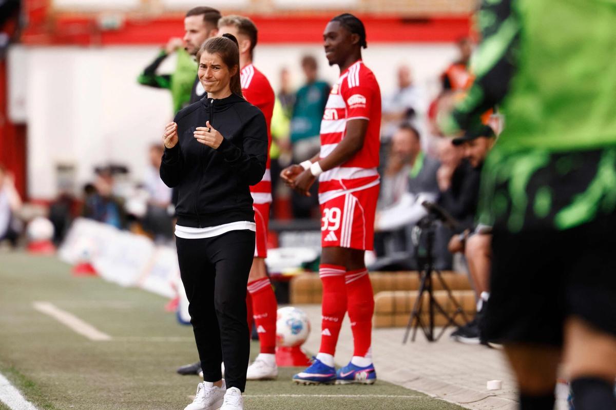 Union Berlin's German head coach Marie-Louise Eta reacts from the sidelines during the German first division Bundesliga football match between Union Berlin and VfL Wolfsburg in Berlin, Germany, on April 18, 2026. (Photo by Odd ANDERSEN / AFP) / DFL REGULATIONS PROHIBIT ANY USE OF PHOTOGRAPHS AS IMAGE SEQUENCES AND/OR QUASI-VIDEO. DFL REGULATIONS PROHIBIT ANY USE OF PHOTOGRAPHS AS IMAGE SEQUENCES AND/OR QUASI-VIDEO