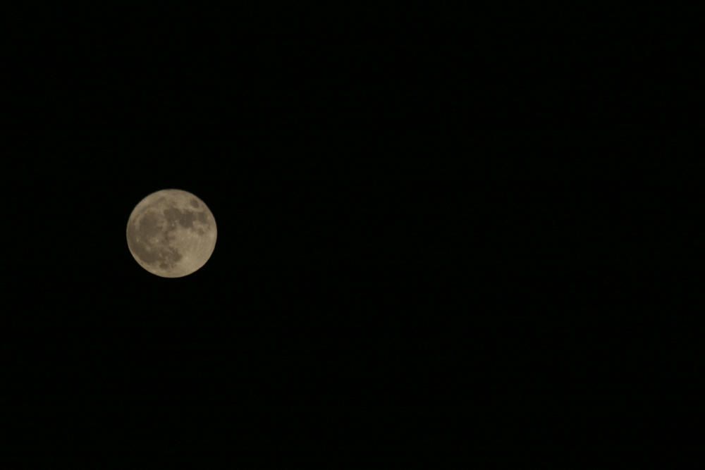 La superluna en Málaga se vio enturbiada por los cielos nubosos de la tarde del lunes.