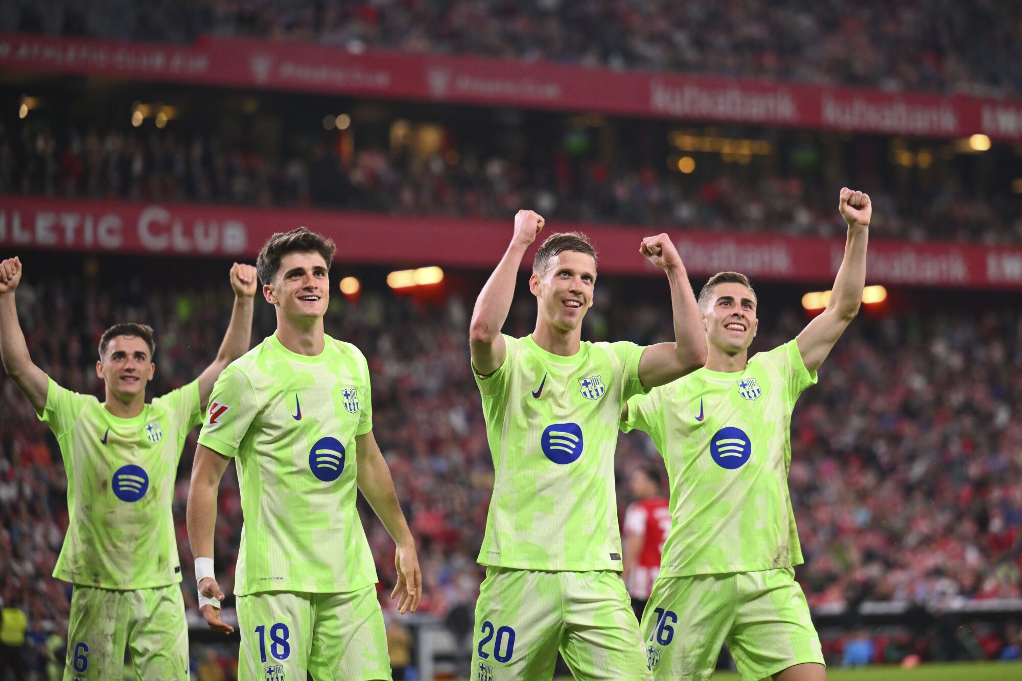 Barcelona's Dani Olmo (20) is congratulated after scoring his side's 3rd goal from the penalty spot during the Spanish La Liga soccer match between Athletic Bilbao and Barcelona at the San Mames stadium in Bilbao, Spain, Sunday, May 25, 2025. (AP Photo/Miguel Oses)