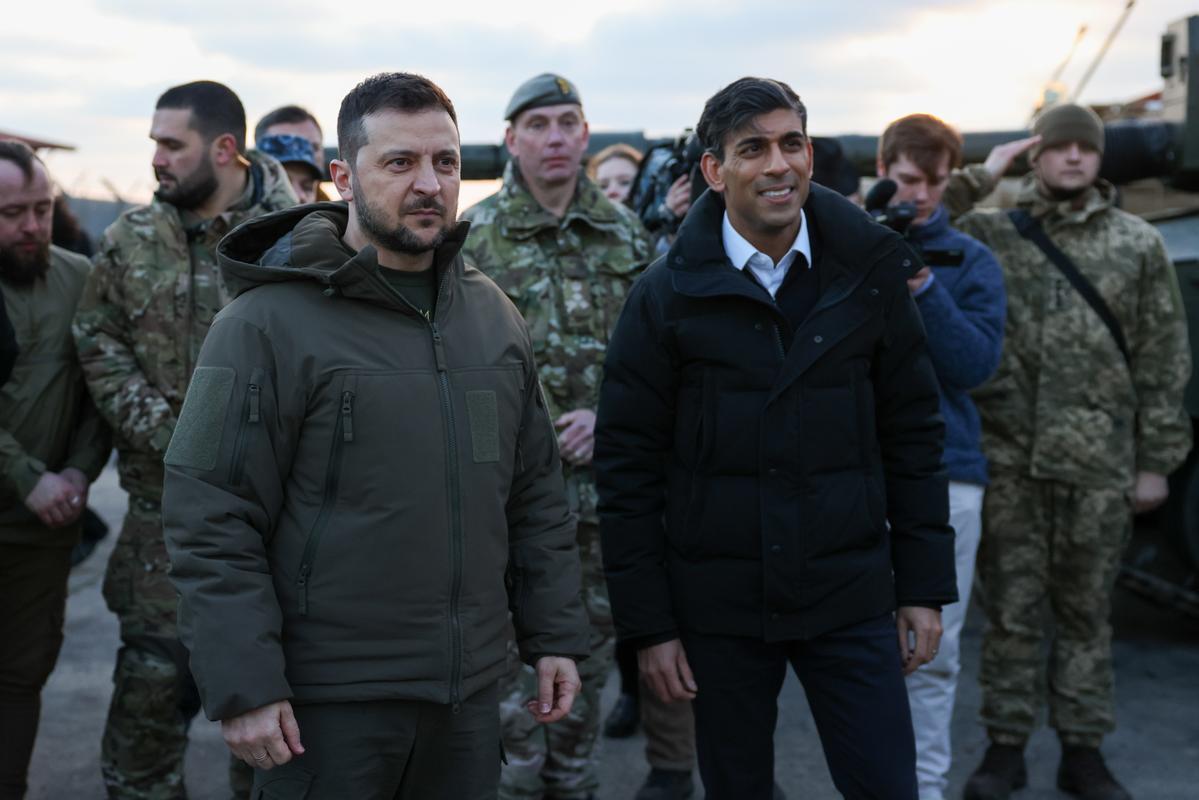 El presidente de Ucrania, Volodimir Zelenski (izq.), y el primer ministro británico, Rishi Sunak (der.), se reúnen con tripulaciones de tanques de las fuerzas armadas de Ucrania que están siendo entrenadas para usar los tanques Challenger 2 por miembros del ejército británico en Lulworth Camp, Gran Bretaña, este miércoles. EFE/EPA/HOLLIE ADAMS / POOL