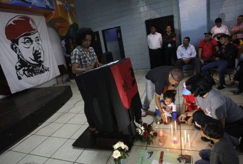 Supporters of Venezuela's President Hugo Chavez light candles as they gather for a vigil at a school for teachers in Tegucigalpa