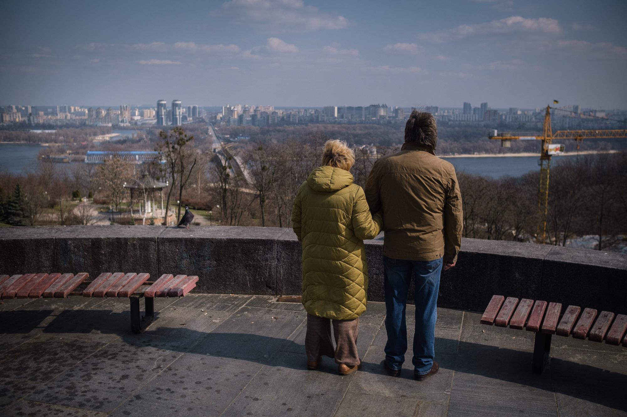Una pareja observa el desastre en Kiev desde un mirador