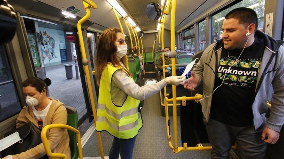 Reparto de mascarillas gratuito en mitad de la pandemia en un autobús de Aucorsa.