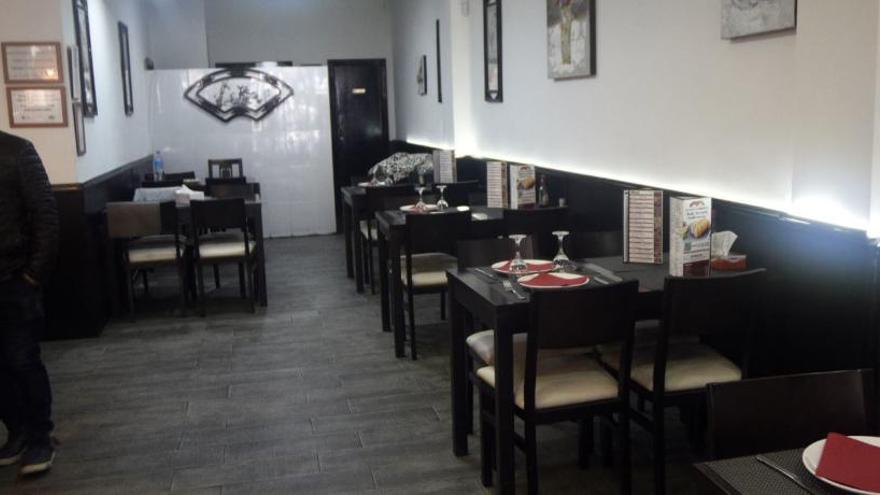 Aijun, chino que lleva cinco años en Murcia, ayer en su restaurante, con todas las mesas vacías.