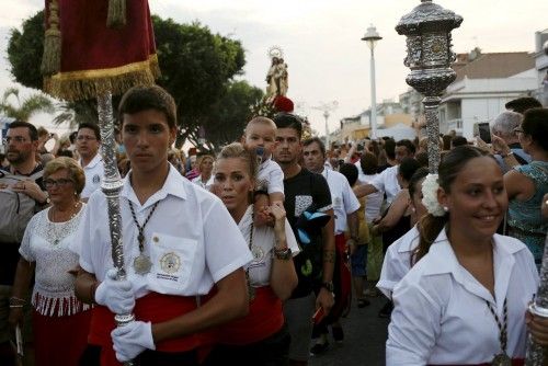 People in traditional costumes take part in the procession of the El Carmen Virgin being carried into the sea in Malaga