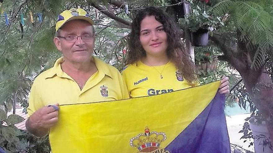 Esteban Díaz y su hija Claudia posan con una bandera y camisetas de la UD. | lp / dlp