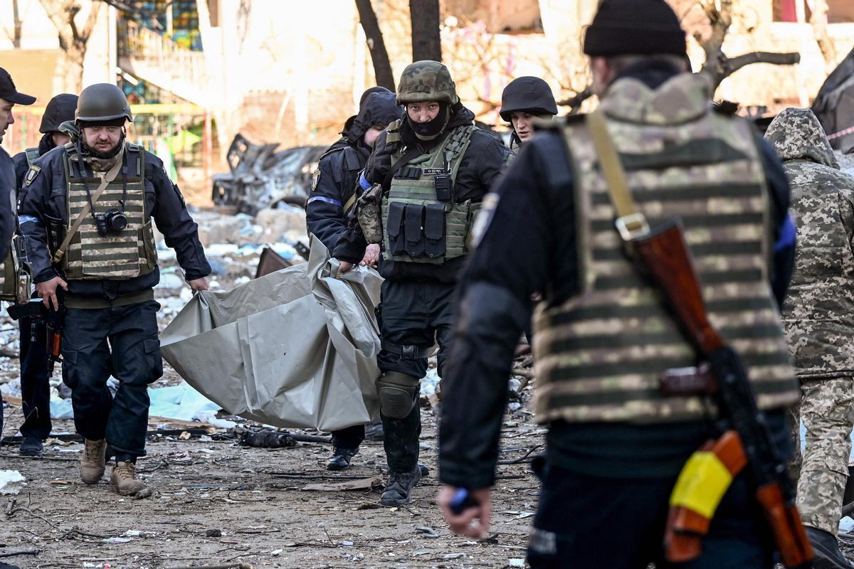 Policías ucranianos trasladan un cuerpo después de que un edificio residencial de Kiev quedara destruido tras un bombardeo.
