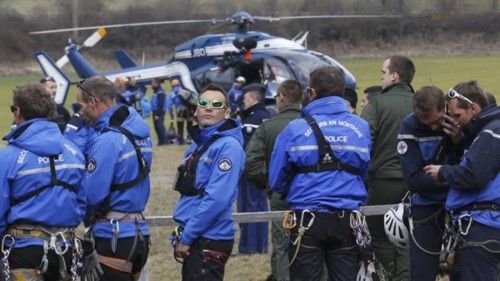 French Police and Gendarmerie Alpine rescue units gather on a field as they prepare to reach the crash site of an Airbus A320