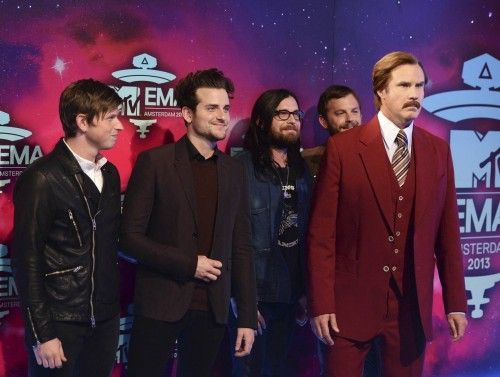 U.S. actor Ferrell, appearing as Burgundy, stands with rock band Kings of Leon at the 2013 MTV Europe Music Awards in Amsterdam