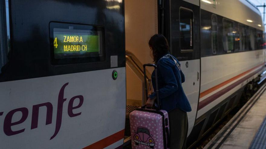 Una mujer entra con su equipaje en el tren Zamora-Madrid