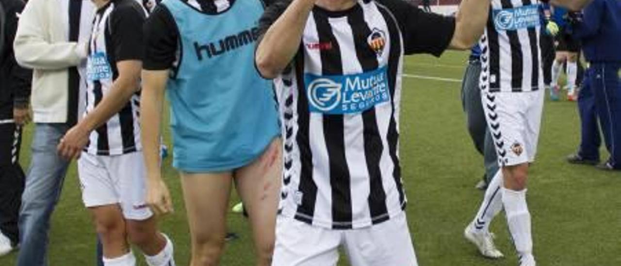 Los jugadores albinegros celebran en el césped su triunfo ante el Atlético Saguntino.