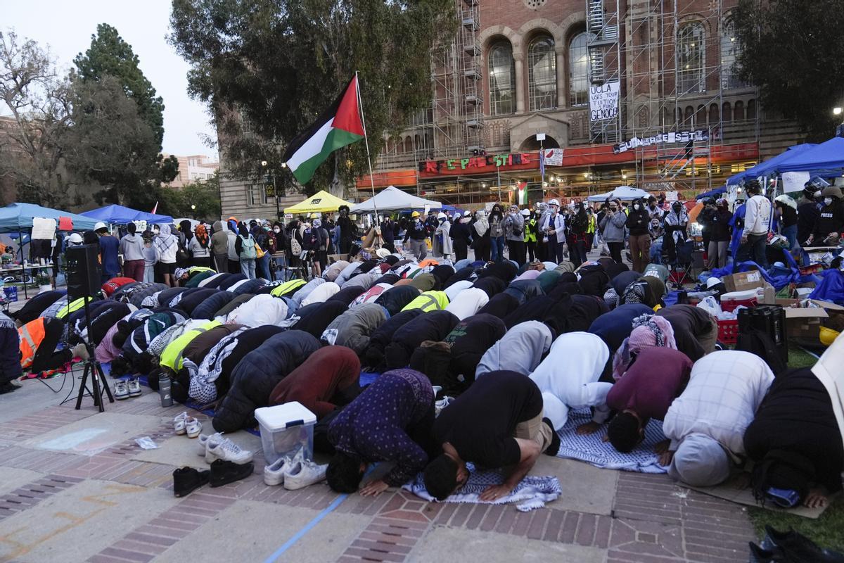 People pray at a pro-Palestinian encampment on the UCLA campus Wednesday, May 1, 2024, in Los Angeles. (AP Photo/Jae C. Hong)