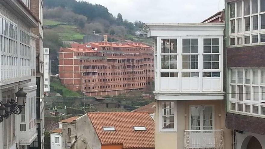 El edificio Mandeo 50, al fondo, y, en primer término, viviendas del casco histórico betanceiro.