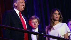 FILE - In this Nov. 9, 2016 file photo, President-elect Donald Trump, left, arrives to speak at an election night rally with his son Barron and wife Melania, in New York. Trump says he will move to the White House but his wife and young son will follow him at the end of the school year. On Sunday, Nov. 20, Trump spoke to reporters gathered at his golf club in Bedminster, N.J., during a day of private meetings with potential administration officials. (AP Photo/Evan Vucci, File)