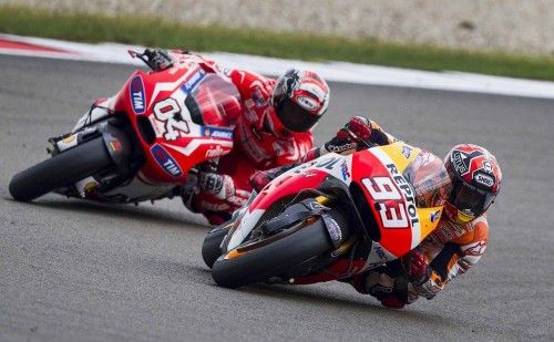 Honda MotoGP rider Marc Marquez of Spain steers his bike past Ducati MotoGP rider Andrea Dovizioso of Italy during the Assen Grand Prix in Assen