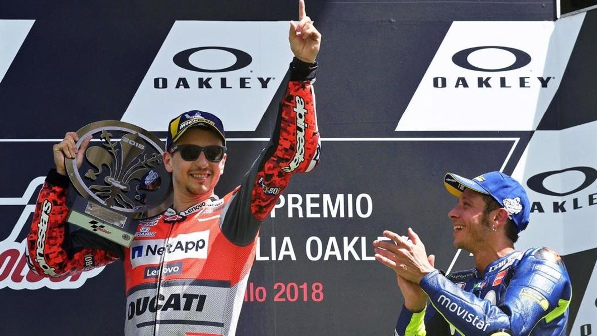 Valentino Rossi, que también salió derrotado de Ducati, aplaude a Jorge Lorenzo en el podio de Mugelo del pasado domingo.